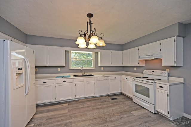 9660 N Dixie Hwy, Franklin Twp, OH 45005 - kitchen featuring white appliances, a sink, under cabinet range hood, white cabinetry, and dark wood finished floors
