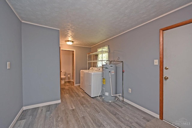 9660 N Dixie Hwy, Franklin Twp, OH 45005 - laundry area with electric water heater, washer and clothes dryer, a textured ceiling, wood finished floors, and baseboards