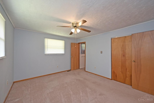 9660 N Dixie Hwy, Franklin Twp, OH 45005 - unfurnished bedroom with carpet flooring, baseboards, a textured ceiling, a closet, and a ceiling fan
