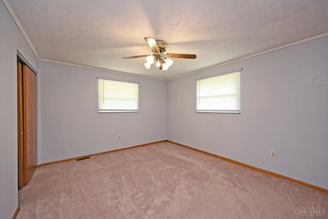 9660 N Dixie Hwy, Franklin Twp, OH 45005 - unfurnished bedroom with light carpet, ornamental molding, a textured ceiling, a closet, and baseboards