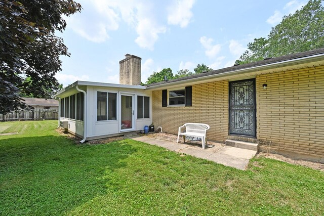 9660 N Dixie Hwy, Franklin Twp, OH 45005 - rear view of house with a chimney, a sunroom, and brick siding
