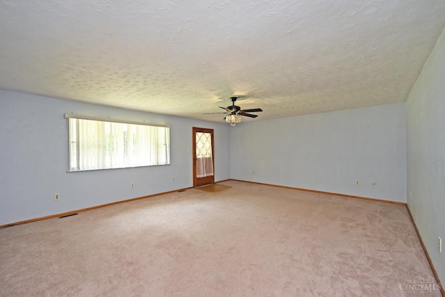 9660 N Dixie Hwy, Franklin Twp, OH 45005 - unfurnished room with light carpet, a ceiling fan, a textured ceiling, and baseboards