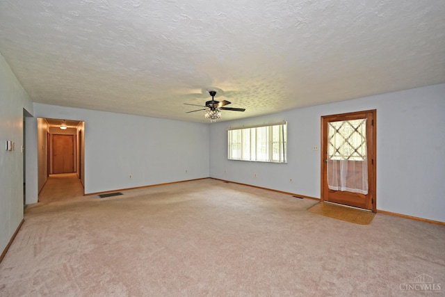 9660 N Dixie Hwy, Franklin Twp, OH 45005 - unfurnished room featuring ceiling fan, light carpet, baseboards, and a textured ceiling