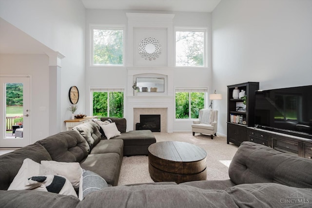 8562 Kempton Ln, Hamilton Twp, OH 45039 - carpeted living area with a high ceiling, a fireplace, and baseboards