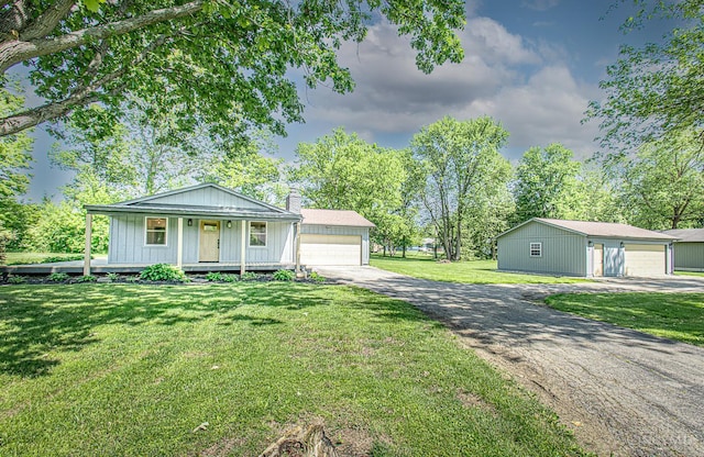 106 Fiord Dr, Lakengren, OH 45320 - view of front of house with a detached garage, an outbuilding, a front yard, and a chimney