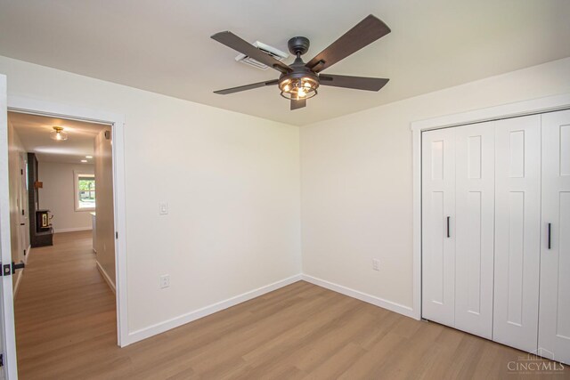 106 Fiord Dr, Lakengren, OH 45320 - unfurnished bedroom featuring light wood finished floors, baseboards, a closet, and a ceiling fan