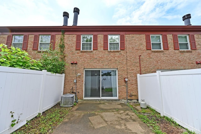 5 Spotswood Cmn, Union Twp, OH 45103 - back of house with a fenced backyard, brick siding, central air condition unit, and a patio