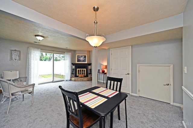 5 Spotswood Cmn, Union Twp, OH 45103 - dining area with carpet, a brick fireplace, a textured ceiling, and baseboards