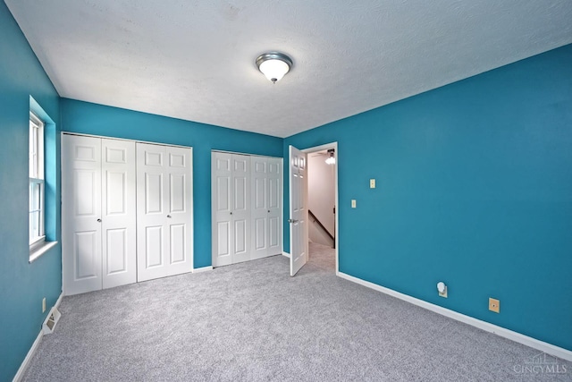 5 Spotswood Cmn, Union Twp, OH 45103 - unfurnished bedroom featuring multiple closets, carpet, and baseboards