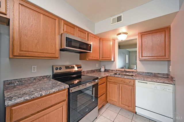 5 Spotswood Cmn, Union Twp, OH 45103 - kitchen featuring stainless steel appliances, a sink, light tile patterned floors, and dark countertops