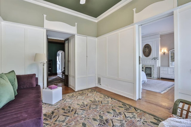 2334 Upland Pl, Cincinnati, OH 45206 - living area with ornamental molding, wood finished floors, a fireplace, and a decorative wall