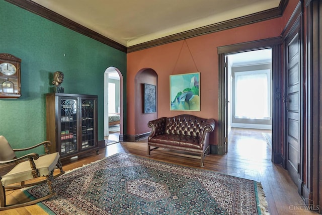 2334 Upland Pl, Cincinnati, OH 45206 - sitting room with arched walkways, crown molding, and wood finished floors