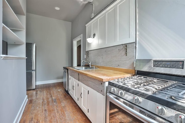 2334 Upland Pl, Cincinnati, OH 45206 - kitchen featuring appliances with stainless steel finishes, white cabinets, tasteful backsplash, and dark wood-style flooring