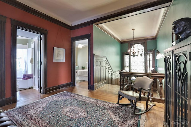 2334 Upland Pl, Cincinnati, OH 45206 - foyer entrance with ornamental molding, wood finished floors, and a chandelier
