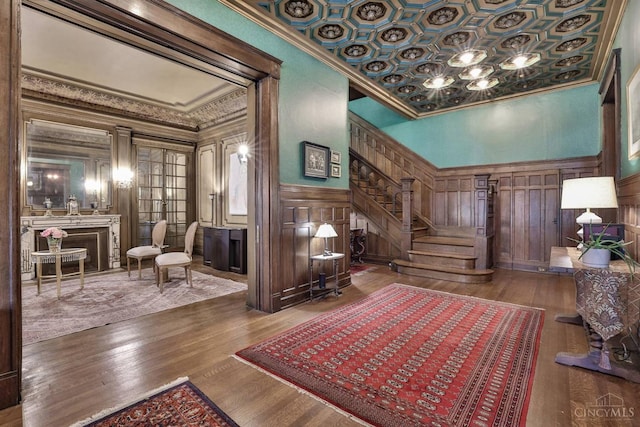 2334 Upland Pl, Cincinnati, OH 45206 - sitting room with ornamental molding, stairway, a decorative wall, wood finished floors, and a fireplace