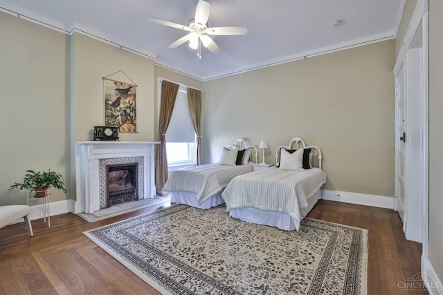2334 Upland Pl, Cincinnati, OH 45206 - bedroom with crown molding, a tile fireplace, wood finished floors, and ceiling fan