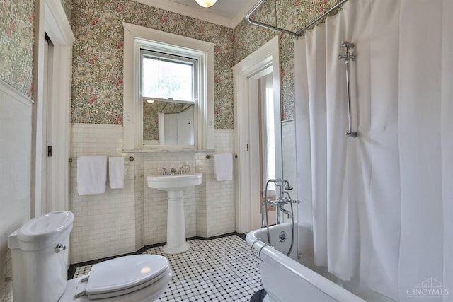 2334 Upland Pl, Cincinnati, OH 45206 - bathroom featuring wallpapered walls, a wainscoted wall, tile walls, and shower / bath combination with curtain