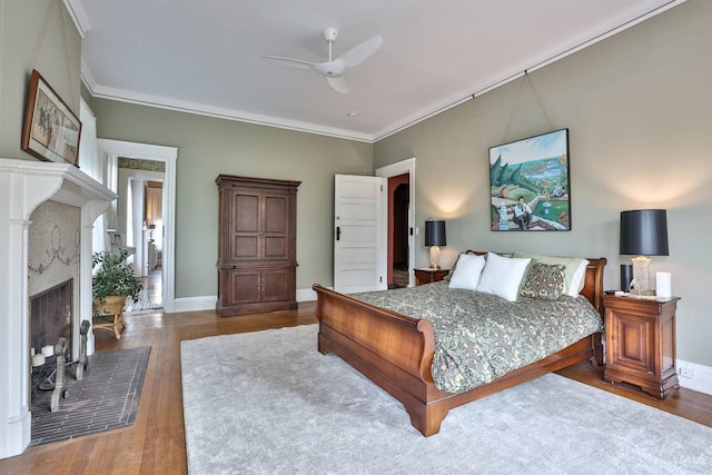 2334 Upland Pl, Cincinnati, OH 45206 - bedroom with a high end fireplace, crown molding, wood finished floors, and a ceiling fan