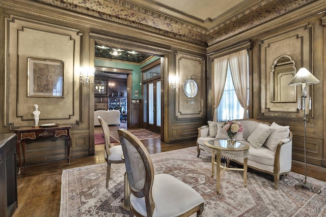 2334 Upland Pl, Cincinnati, OH 45206 - living area with ornamental molding, dark wood-style floors, and a decorative wall