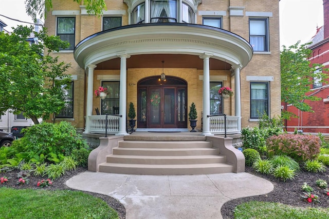 2334 Upland Pl, Cincinnati, OH 45206 - doorway to property featuring brick siding and covered porch
