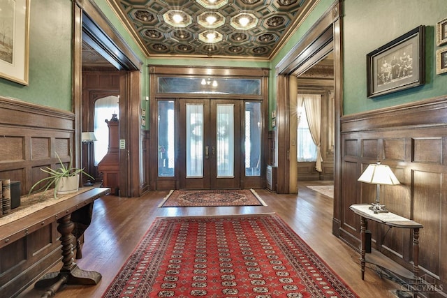 2334 Upland Pl, Cincinnati, OH 45206 - foyer featuring crown molding, wood finished floors, a decorative wall, coffered ceiling, and wood walls
