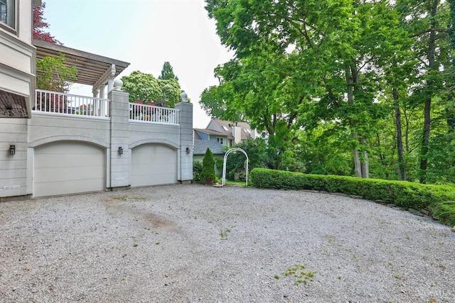 2334 Upland Pl, Cincinnati, OH 45206 - view of front of property with gravel driveway, a balcony, and a garage