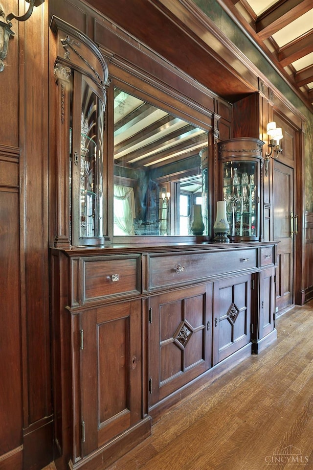 2334 Upland Pl, Cincinnati, OH 45206 - bar area featuring wooden walls, wood finished floors, and beamed ceiling