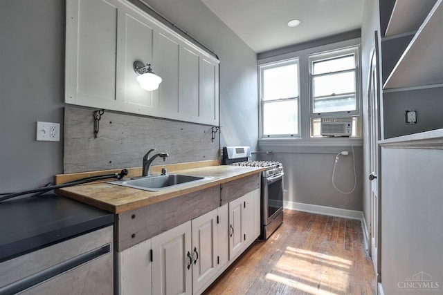 2334 Upland Pl, Cincinnati, OH 45206 - kitchen featuring stainless steel gas range, white cabinetry, hardwood / wood-style floors, decorative backsplash, and cooling unit