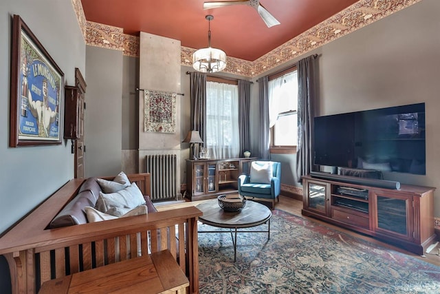 2334 Upland Pl, Cincinnati, OH 45206 - living area with radiator heating unit, a chandelier, a ceiling fan, and wood finished floors