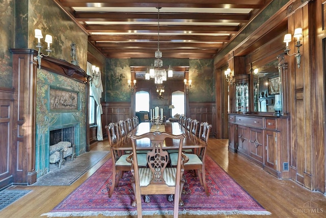2334 Upland Pl, Cincinnati, OH 45206 - dining room with wood finished floors, a chandelier, beamed ceiling, a high end fireplace, and a decorative wall