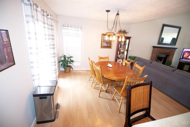 4840 Shannon Way, Middletown, OH 45042 - dining area with wood finished floors and a fireplace