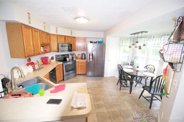 4840 Shannon Way, Middletown, OH 45042 - kitchen with stainless steel appliances, light countertops, brown cabinets, and a peninsula