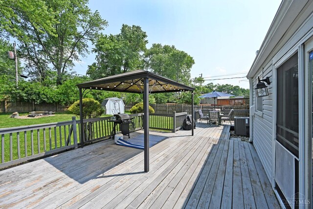 2868 Grosvenor Dr, Colerain Twp, OH 45251 - wooden deck with an outdoor fire pit, outdoor dining area, central AC unit, area for grilling, and a gazebo