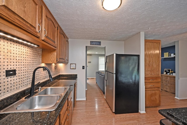 2868 Grosvenor Dr, Colerain Twp, OH 45251 - kitchen featuring freestanding refrigerator, a sink, light wood-style flooring, baseboards, and a textured ceiling