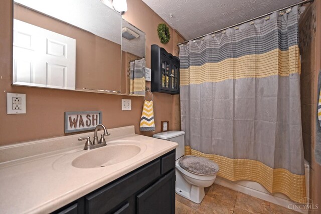 2868 Grosvenor Dr, Colerain Twp, OH 45251 - bathroom with toilet, vanity, a textured ceiling, tile patterned flooring, and shower / bath combo with shower curtain