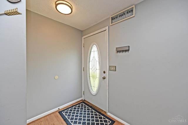 2868 Grosvenor Dr, Colerain Twp, OH 45251 - foyer with wood finished floors, baseboards, and a textured ceiling