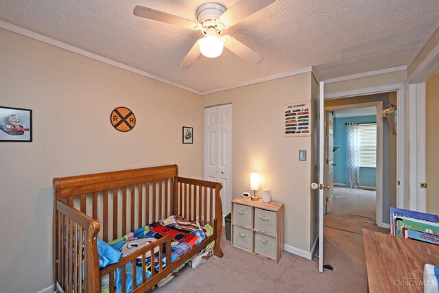 2868 Grosvenor Dr, Colerain Twp, OH 45251 - carpeted bedroom featuring a closet, ornamental molding, a textured ceiling, baseboards, and ceiling fan