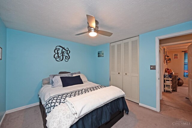 2868 Grosvenor Dr, Colerain Twp, OH 45251 - bedroom featuring a closet, light carpet, baseboards, ceiling fan, and a textured ceiling