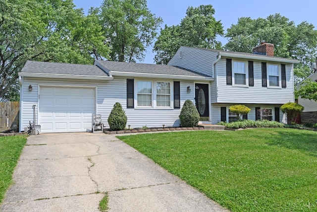 2868 Grosvenor Dr, Colerain Twp, OH 45251 - tri-level home with a garage, a chimney, and concrete driveway