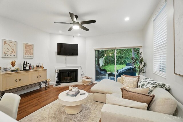 983 Paradrome St Unit A, Cincinnati, OH 45202 - living room featuring wood finished floors, a ceiling fan, a fireplace with raised hearth, and recessed lighting