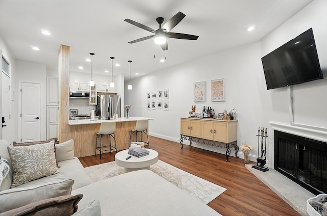983 Paradrome St Unit A, Cincinnati, OH 45202 - living area featuring ceiling fan, dark wood-type flooring, baseboards, recessed lighting, and a fireplace with raised hearth
