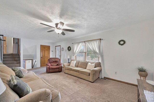 55 Kastrup Dr, Lakengren, OH 45320 - carpeted living room with ceiling fan, a textured ceiling, stairway, and baseboards