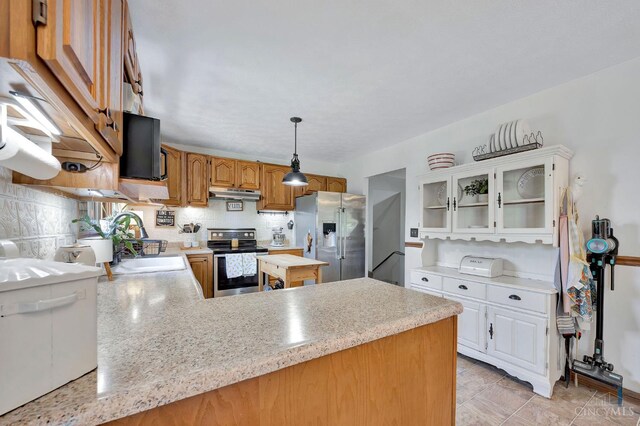 55 Kastrup Dr, Lakengren, OH 45320 - kitchen featuring appliances with stainless steel finishes, a sink, light countertops, under cabinet range hood, and a peninsula