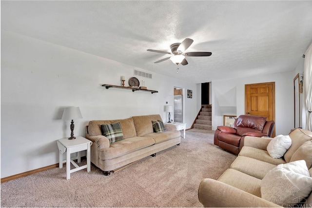 55 Kastrup Dr, Lakengren, OH 45320 - living area featuring carpet floors, stairs, a textured ceiling, a ceiling fan, and baseboards