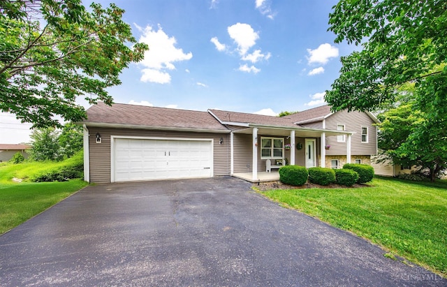 55 Kastrup Dr, Lakengren, OH 45320 - split level home featuring a porch, driveway, a front lawn, and an attached garage