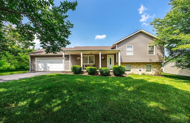 55 Kastrup Dr, Lakengren, OH 45320 - tri-level home featuring driveway, a front lawn, an attached garage, and covered porch