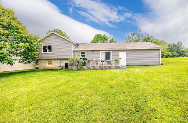 55 Kastrup Dr, Lakengren, OH 45320 - rear view of house featuring a wooden deck, a lawn, central air condition unit, and stone siding