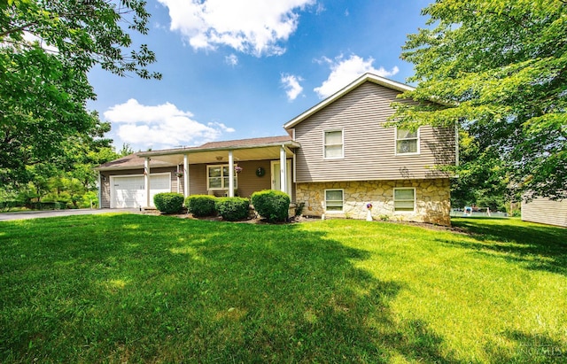 55 Kastrup Dr, Lakengren, OH 45320 - split level home featuring a front lawn, a garage, stone siding, and driveway