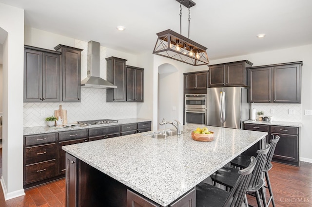 3779 Sturbridge Way, Pierce Twp, OH 45245 - kitchen with stainless steel appliances, wall chimney exhaust hood, a sink, dark wood-style floors, and decorative backsplash