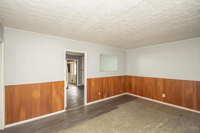 800 Richardson Dr, Middletown, OH 45042 - unfurnished room with wood finished floors, wooden walls, a wainscoted wall, and ornamental molding